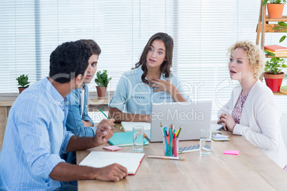 Group of young colleagues using laptop