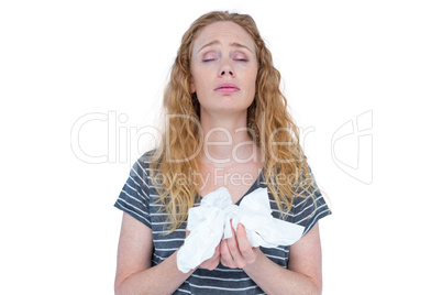 Sick blonde woman holding paper tissue