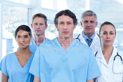 Team of serious doctors looking at camera Team of serious doctors looking at camera