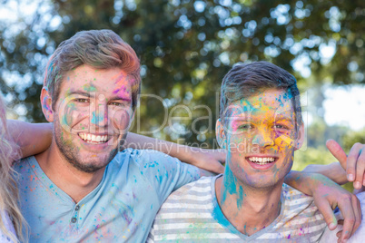 Happy friends covered in powder paint