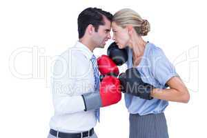 Business people wearing and boxing red gloves
