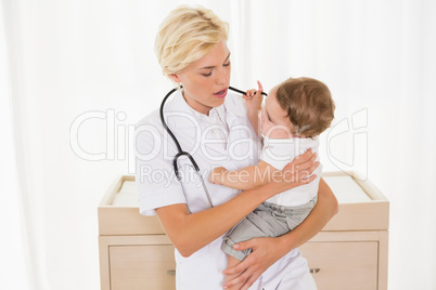 Blonde doctor examined a child