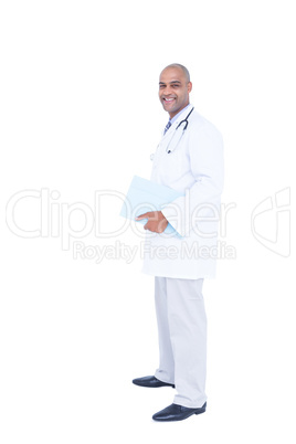 Standing doctor in white tunic writing notes