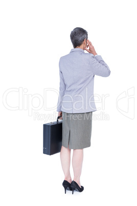 Wear view of businesswoman stranding with suitcase