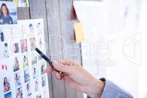 Creative businesswoman pointing pictures with pen