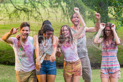 Happy friends covered in powder paint