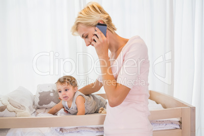 Smiling blonde woman with his son phoning