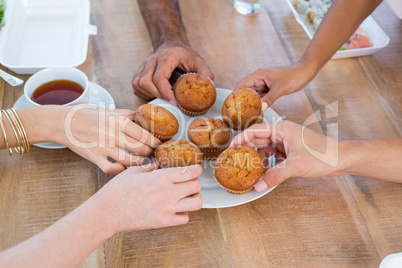 People taking a cupcake