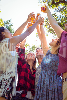 Happy friends in the park having beers