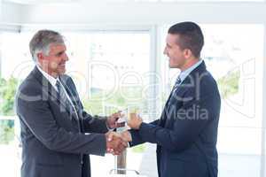Businessmen shaking hands and exchanging money
