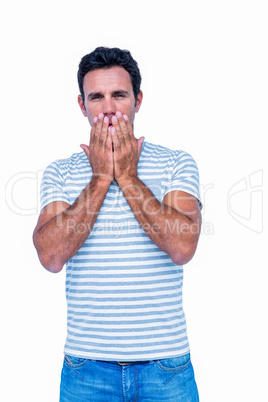 Sad man with his hands on his mouth