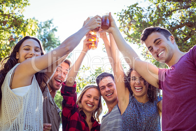 Happy friends in the park having beers