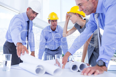 team of business people looking at construction plan