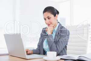 Smiling businesswoman using her computer