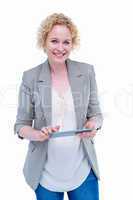 Pretty hipster smiling at camera and holding tablet