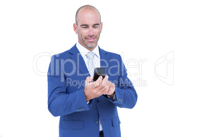 happy businessman playing with his smartphone