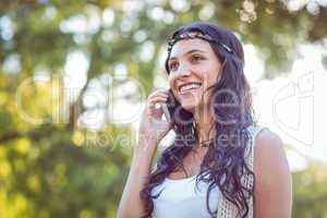 Pretty hipster on the phone in the park