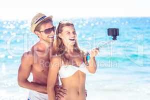 Happy couple taking selfie with selfie stick