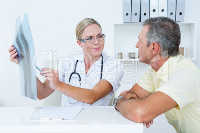 Doctor showing X rays to her patient