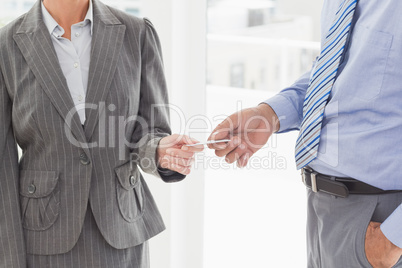 Businessman giving his business card to his colleague