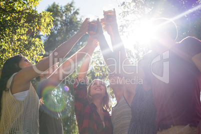 Happy friends in the park having beers