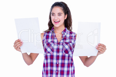 Pretty brunette looking at paper sheet