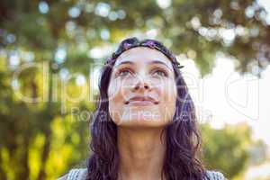 Pretty hipster smiling in the park