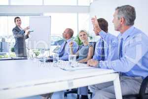 Businessman asking question during meeting