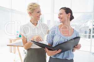 Smiling businesswomen working together