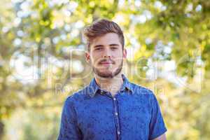 Handsome hipster looking at camera
