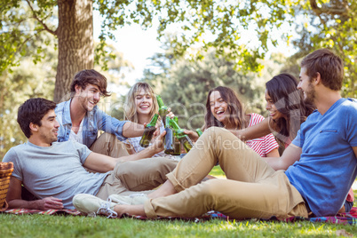 Happy friends in the park having picnic