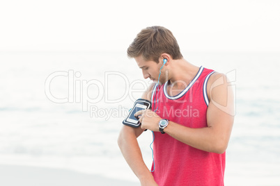 Handsome runner using his phone