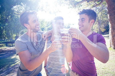 Happy friends in the park having beers