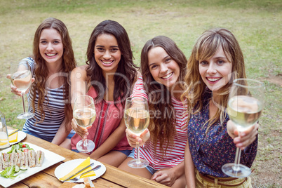 happy friends in a park having a picnic