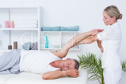 Doctor examining her patient arm