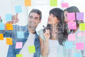Young creative business people looking at photo editor