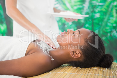 Pretty woman enjoying a salt scrub massage