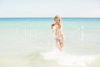 Happy pretty woman taking water into her hands