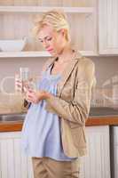 Blonde pregnancy taking a vitamin
