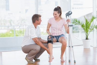 Doctor examining his patient knee