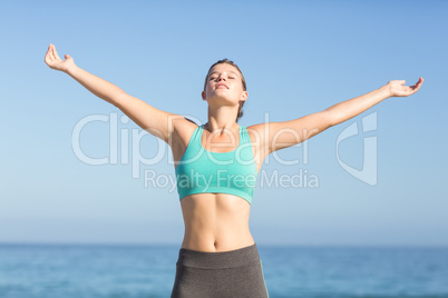 Beautiful fit woman relaxing in front of sea