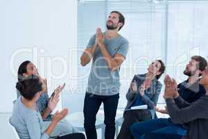 Rehab group applauding delighted man standing up