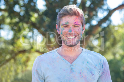 Happy man covered in powder paint