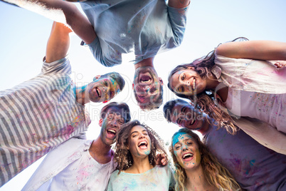 Happy friends covered in powder paint