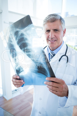 Smiling doctor analyzing xray