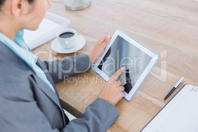 Concentrating businesswoman using a tablet