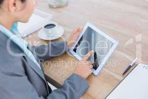 Concentrating businesswoman using a tablet