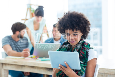 Smiling young women using digital tablet