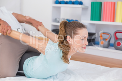 Woman stretching with her trainer