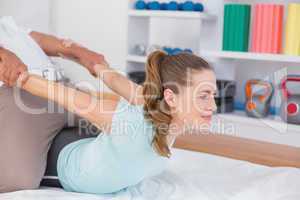 Woman stretching with her trainer